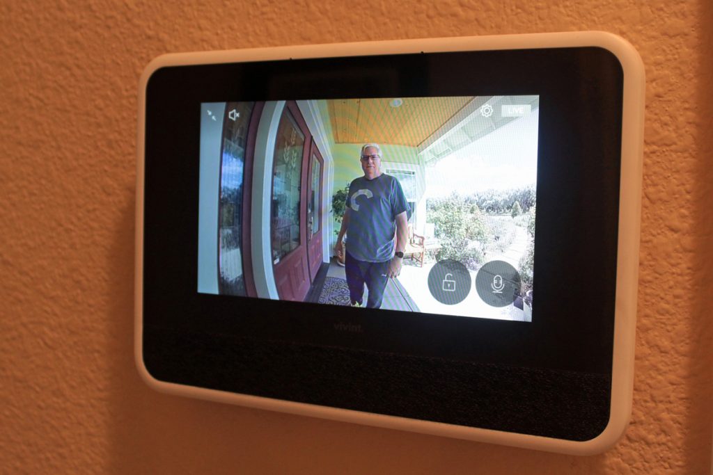 Man near front door pressed video doorbell