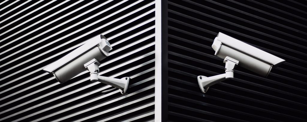 Two digital security cameras on building